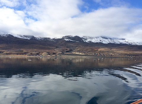 Boat view of Qullissat, Greenland – the birthplace of Kuupik Kleist, one of the three Pikialasorsuaq Commissioners.